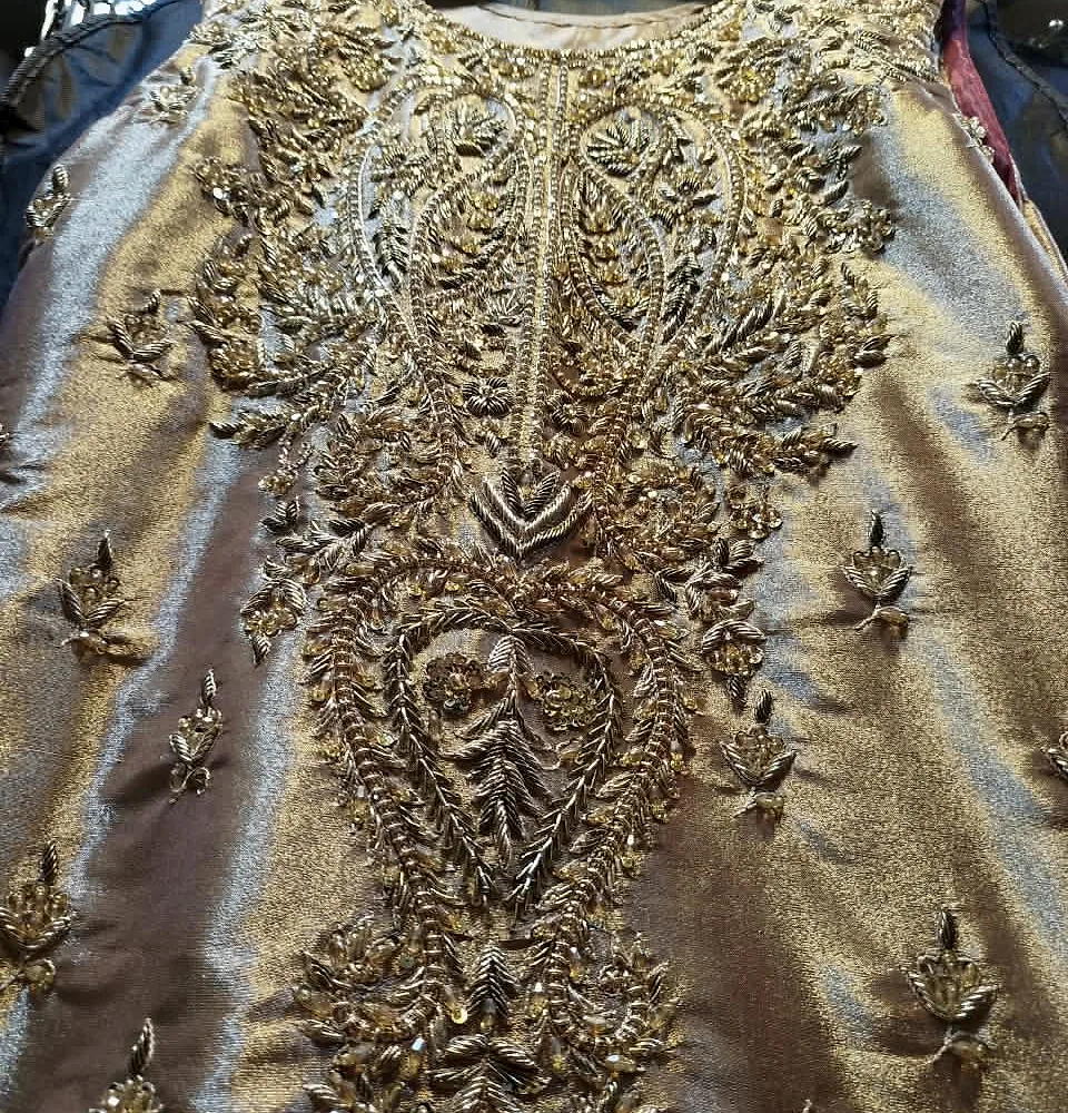 Close-up of off-white tissue silk and golden zari handwork