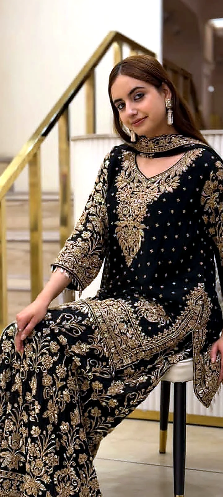 Black and gold heavy formal dress seated full view